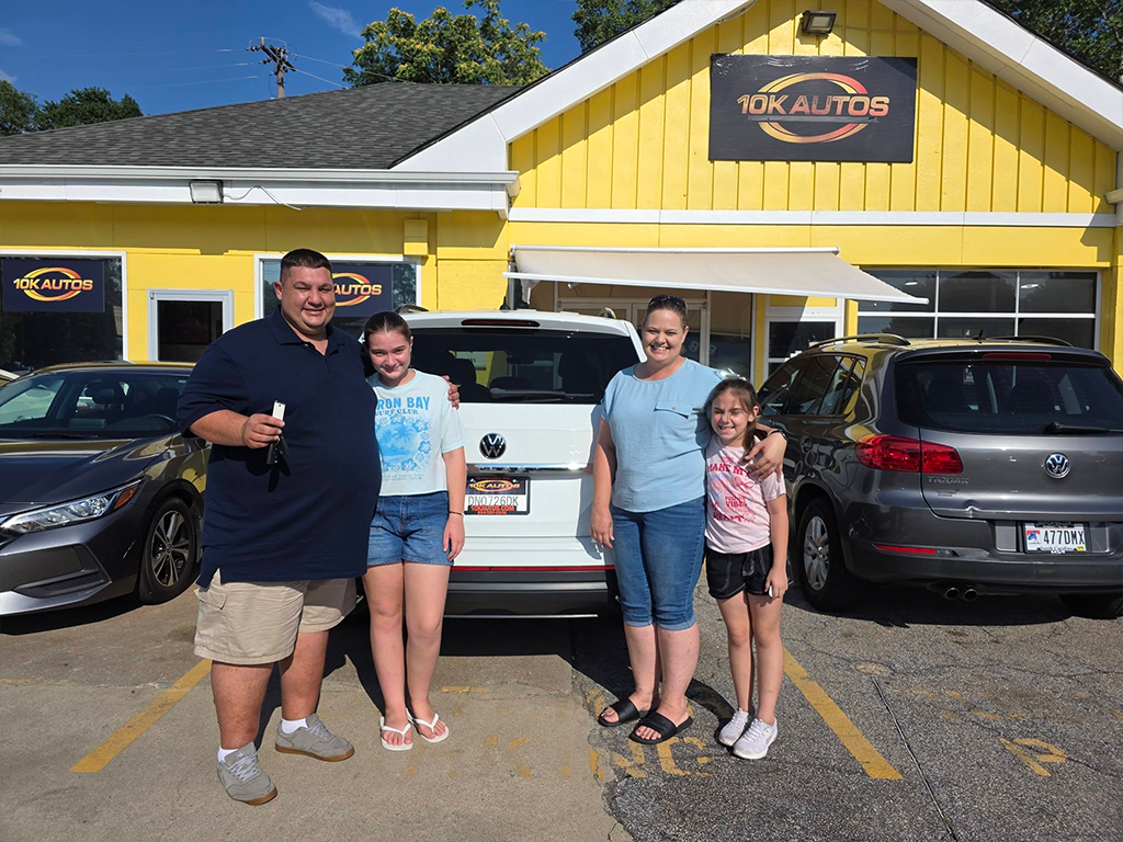 Happy 10K Autos customers with their new vehicle in Greenville, SC